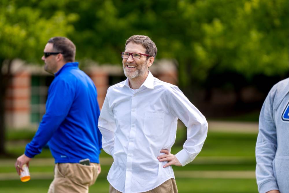 A player stands with hands on hips smiling